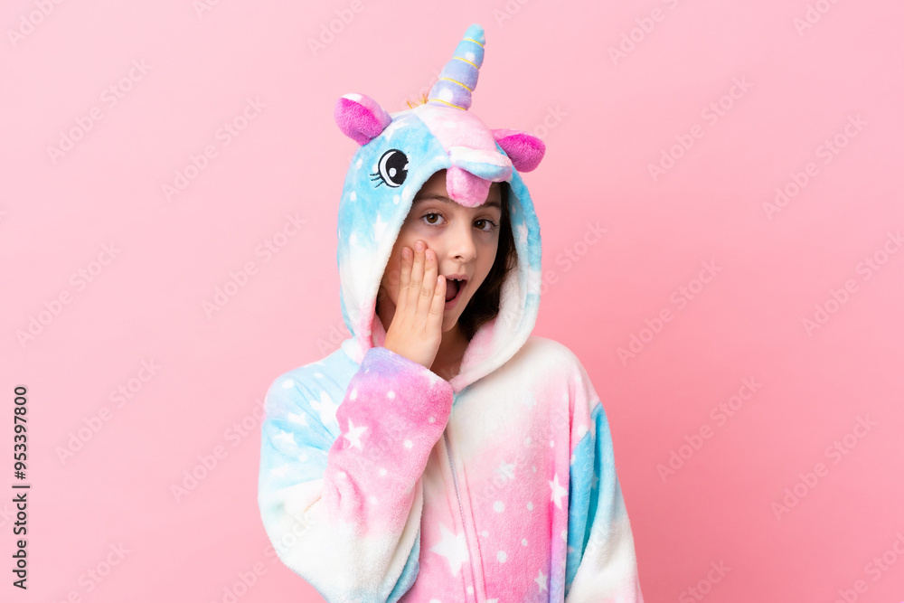 Little caucasian woman wearing a unicorn pajama isolated on pink background with surprise and shocked facial expression Little caucasian woman wearing a unicorn pajama isolated on pink background with surprise and shocked facial expression