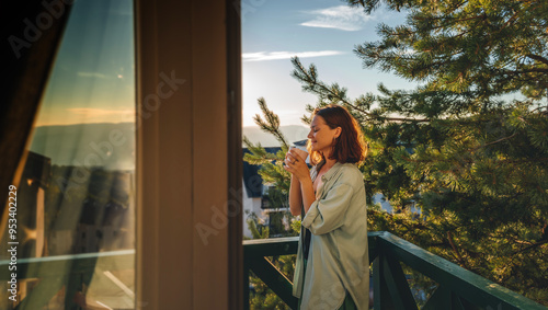 Obraz na płótnie Young woman greeting the morning at dawn standing on a balcony overlooking the mountains w salonie