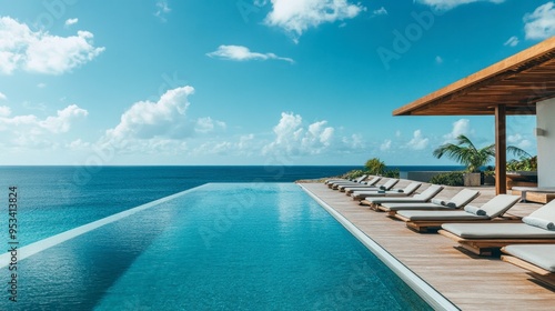 A rooftop swimming pool in a luxury hotel, with lounge chairs and a stunning view of the ocean beyond.