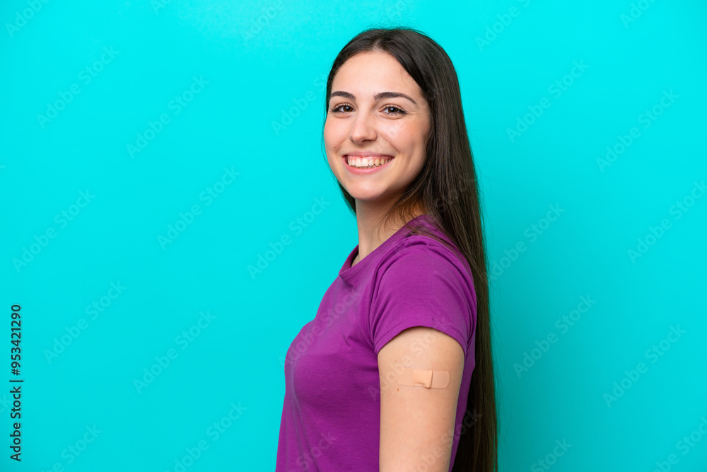 Young girl with band-aids isolated on blue background smiling a lot Young girl with band-aids isolated on blue background smiling a lot