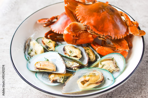 a plate of seafood such as green mussels and crab photo