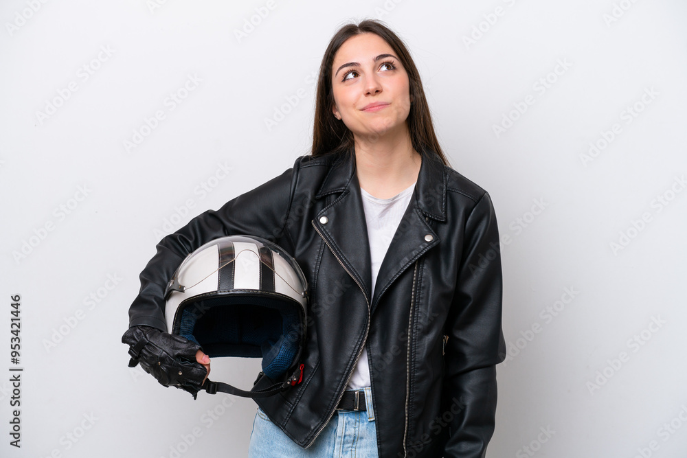 Young girl with a motorcycle helmet isolated on white background and looking up Young girl with a motorcycle helmet isolated on white background and looking up
