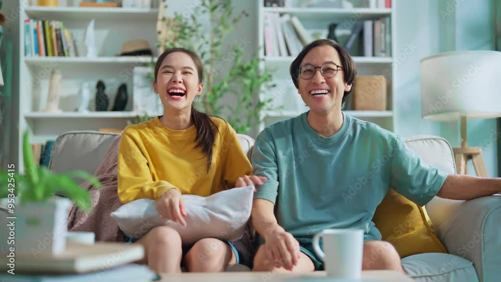 funny humor family moment asian marry love couple family enjoy watch tv comedy show on tv in sunday morning weekend on sofa embrace sweet relation positive vibes they laugh together on sofa at home funny humor family moment asian marry love couple family enjoy watch tv comedy show on tv in sunday morning weekend on sofa embrace sweet relation positive vibes they laugh together on sofa at home