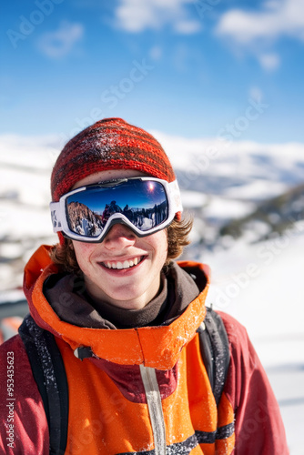 Teenager dressed in skiing or snowboarding gear in a snowy alpine landscape. Vertical with copy space.