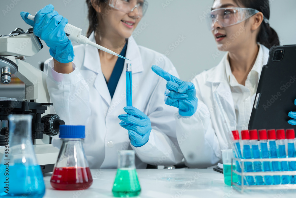 Scientist works with a pipette and a test tube. Scientific laboratory of biotechnology, development of medicine and research in chemistry, biochemistry and experiments. Scientist works with a pipette and a test tube. Scientific laboratory of biotechnology, development of medicine and research in chemistry, biochemistry and experiments.