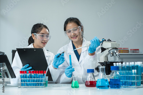 Scientist works with a pipette and a test tube. Scientific laboratory of biotechnology, development of medicine and research in chemistry, biochemistry and experiments.