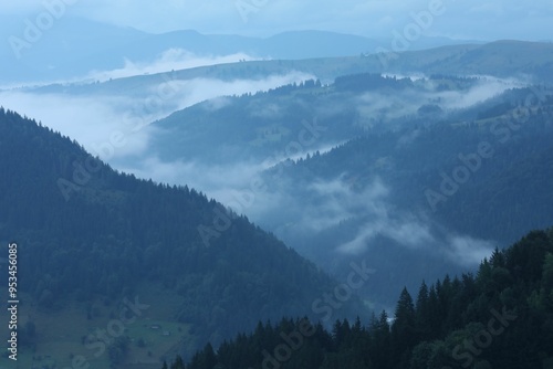 Picturesque view of beautiful mountains covered with fog