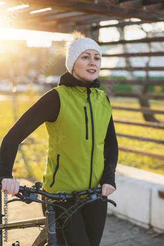 Woman Standing Next to Bike in Park photo