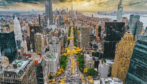 Bird's eye view of Manhattan, looking down at people and yellow taxi going to down 4th Avenue.