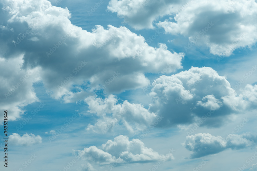 Fototapeta premium Clouds and dark clouds on a beautiful blue sky, dramatic tones in the sky