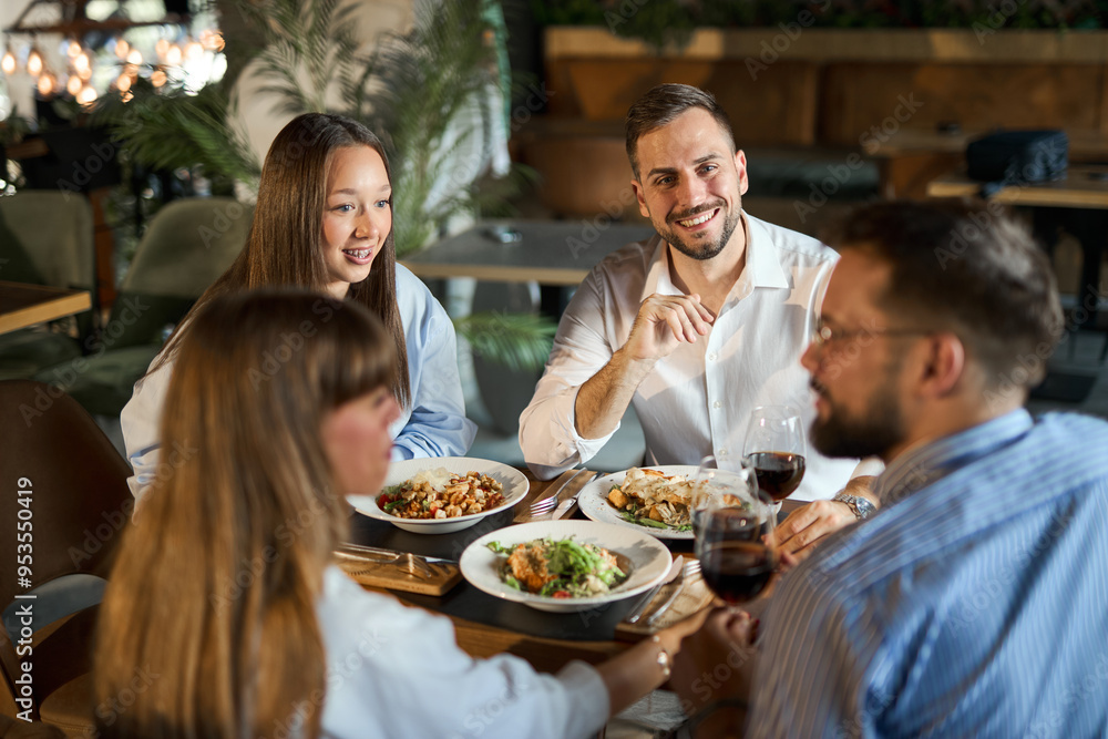 Group of cheerful entrepreneurs talking while enjoying in their lunch at a restaurant. Group of cheerful entrepreneurs talking while enjoying in their lunch at a restaurant.