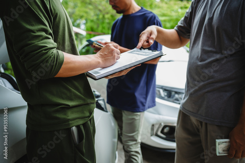 Three Asian men discussing car insurance policies with adjuster. They review details such as premiums, deductibles, coverage options while handling recent claim and evaluating the settlement process.