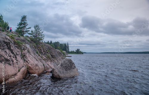 
High rocky shores above the water surface. There are mixed forests around.