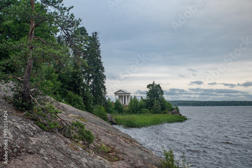 
High rocky shores above the water surface. There are mixed forests around.