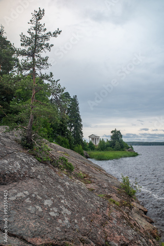 
High rocky shores above the water surface. There are mixed forests around.