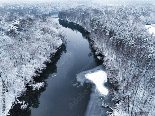 Flying above snowy forest a...