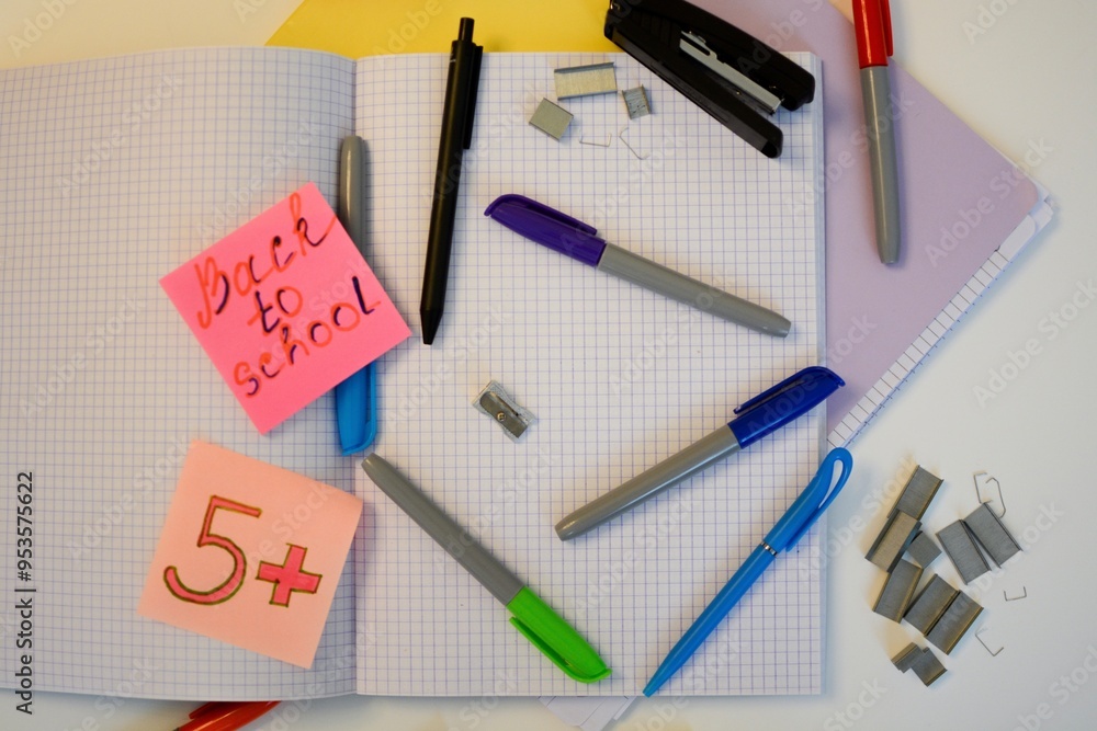 scribbled notebooks and pens with colored felt-tip pens for studying at school on a white desk scribbled notebooks and pens with colored felt-tip pens for studying at school on a white desk