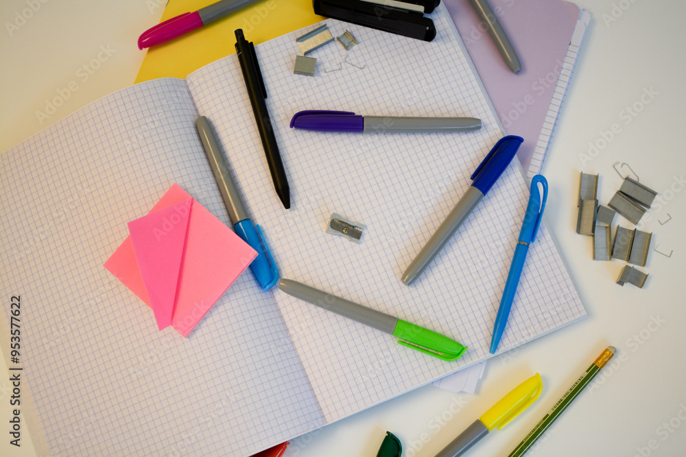 scribbled notebooks and pens with colored felt-tip pens for studying at school on a white desk scribbled notebooks and pens with colored felt-tip pens for studying at school on a white desk