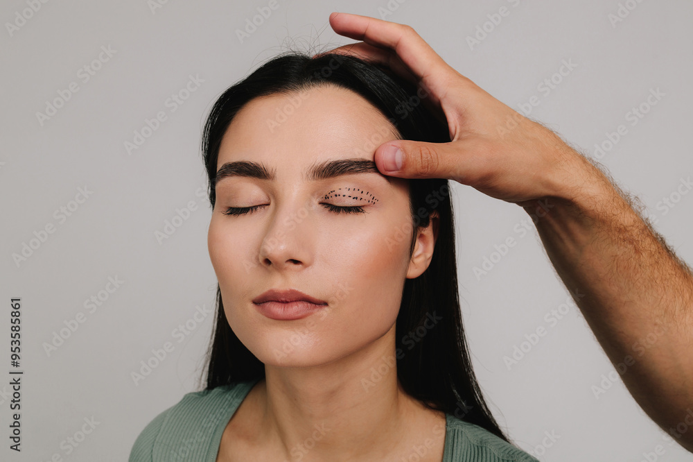 Marking blepharoplasty. Doctor is drawing up plan for upper eye lid surgery with medical marker. Lifting eye lids with precise planning. Marking blepharoplasty. Doctor is drawing up plan for upper eye lid surgery with medical marker. Lifting eye lids with precise planning.
