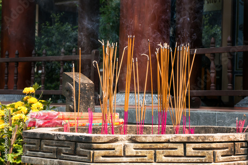Smoke from incense sticks inside old temple in China Town.