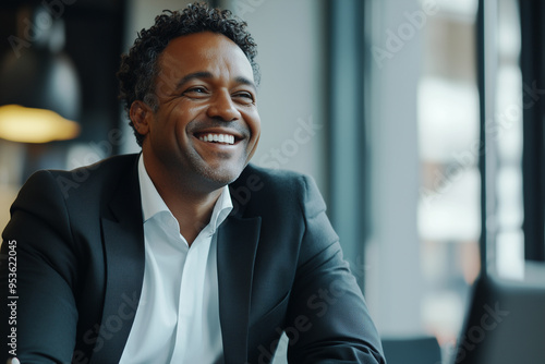 Businessman with a joyful expression, captured in a close-up shot smilling