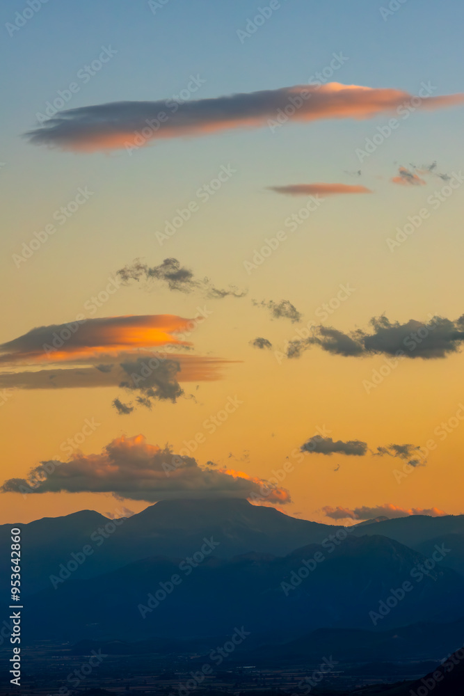 Obraz premium Sunset Clouds over Mountain Silhouettes