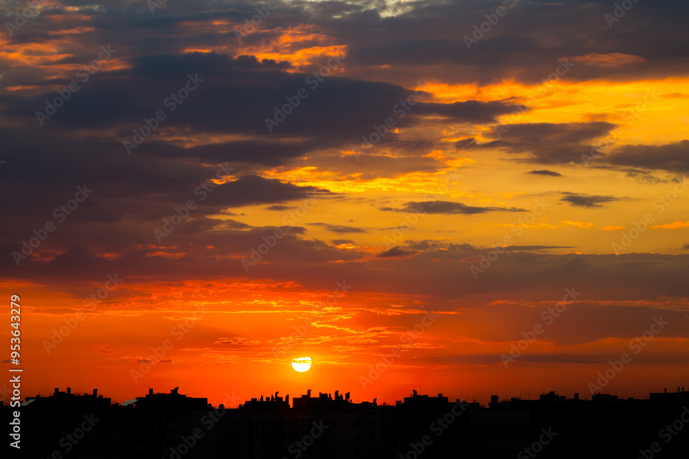 Setting Sun in the Clouds over the City Rooftops Setting Sun in the Clouds over the City Rooftops