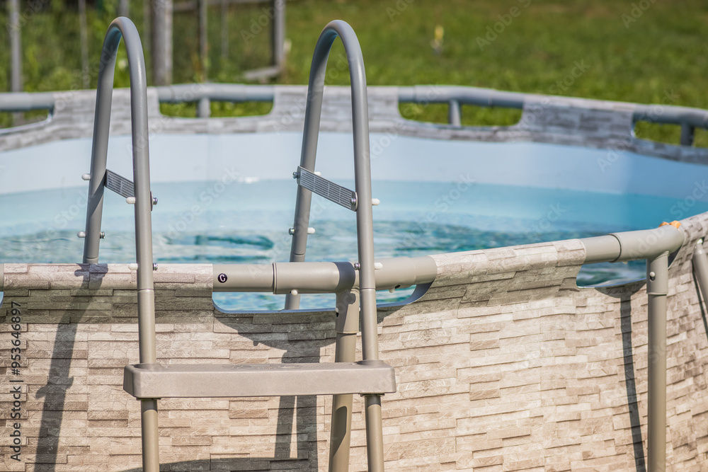 A Beautiful Above Ground Pool with a Ladder and Crystal Clear Water on a Wonderful Sunny Day A Beautiful Above Ground Pool with a Ladder and Crystal Clear Water on a Wonderful Sunny Day