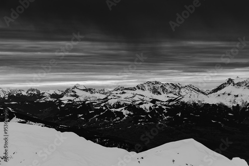 Panorama of the ski resort in alps. drama sky, mountain peaks, ski lift, skiers. high resolution photo.