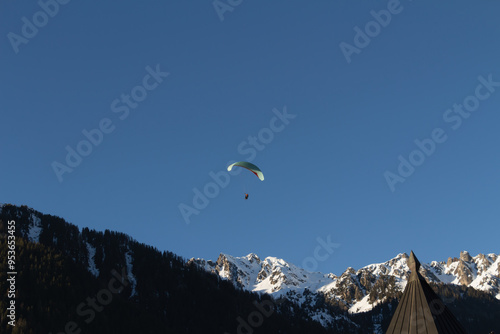 Paraplan and deltaplan in alps over a ski resort
