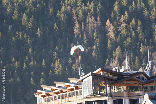 Paraplan and deltaplan in alps over a ski resort