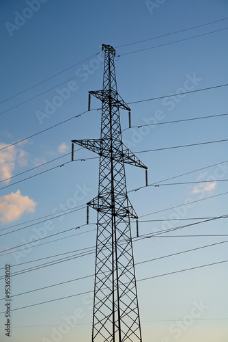 Power lines with wires on blue sky with clouds