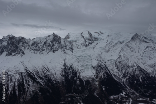 Panorama of the ski resort in alps. drama sky, mountain peaks, ski lift, skiers. high resolution photo.
