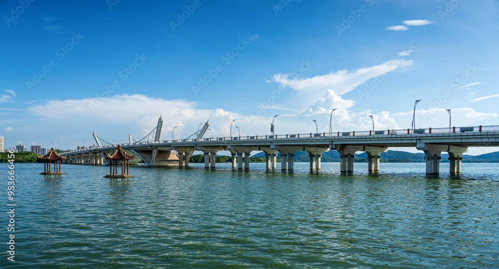 Majestic Modern Bridge Spanning Tranquil Waters Under a Clear Blue Sky Majestic Modern Bridge Spanning Tranquil Waters Under a Clear Blue Sky