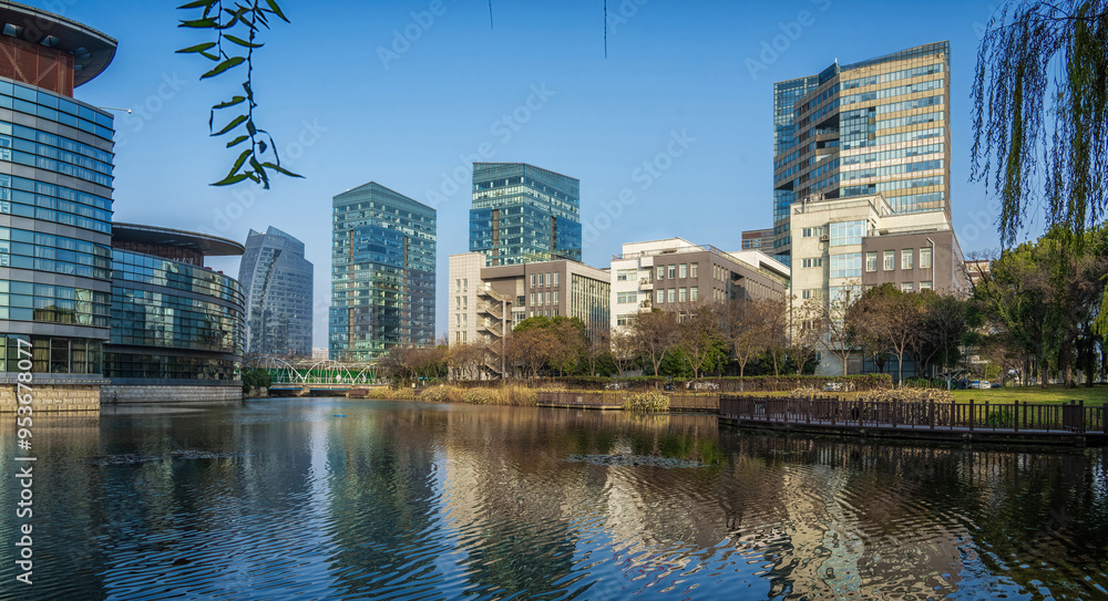 Fototapeta premium Serene Urban Park with Modern Buildings Reflection