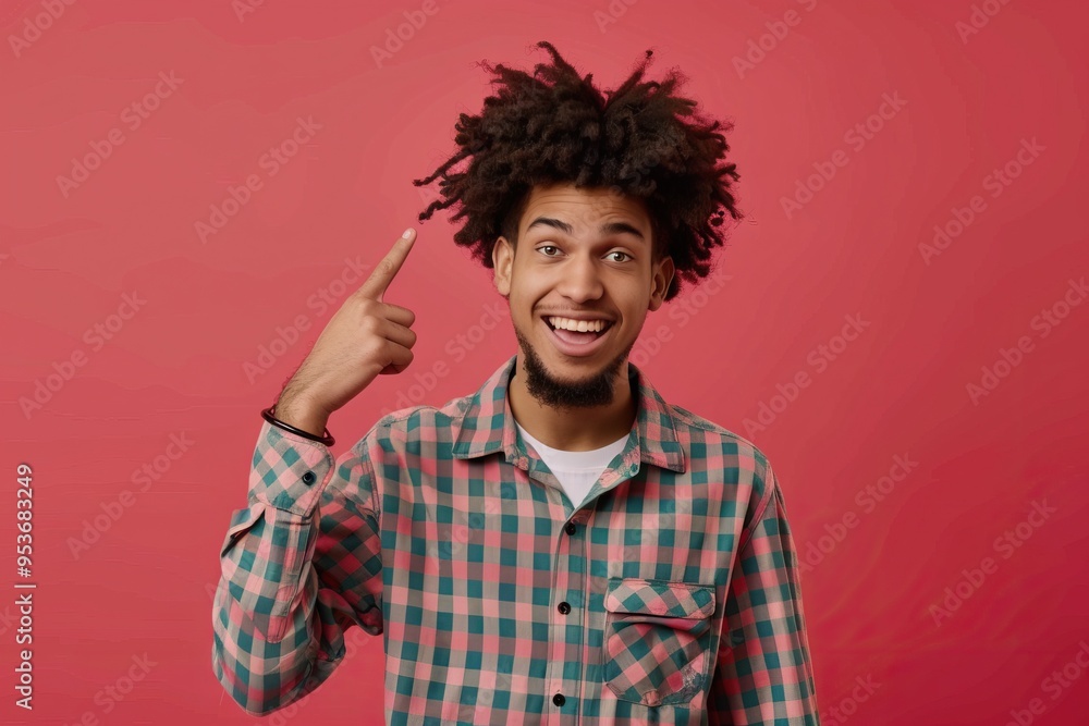 Happy male student with afro hair pointing and smiling. Happy male student with afro hair pointing and smiling.