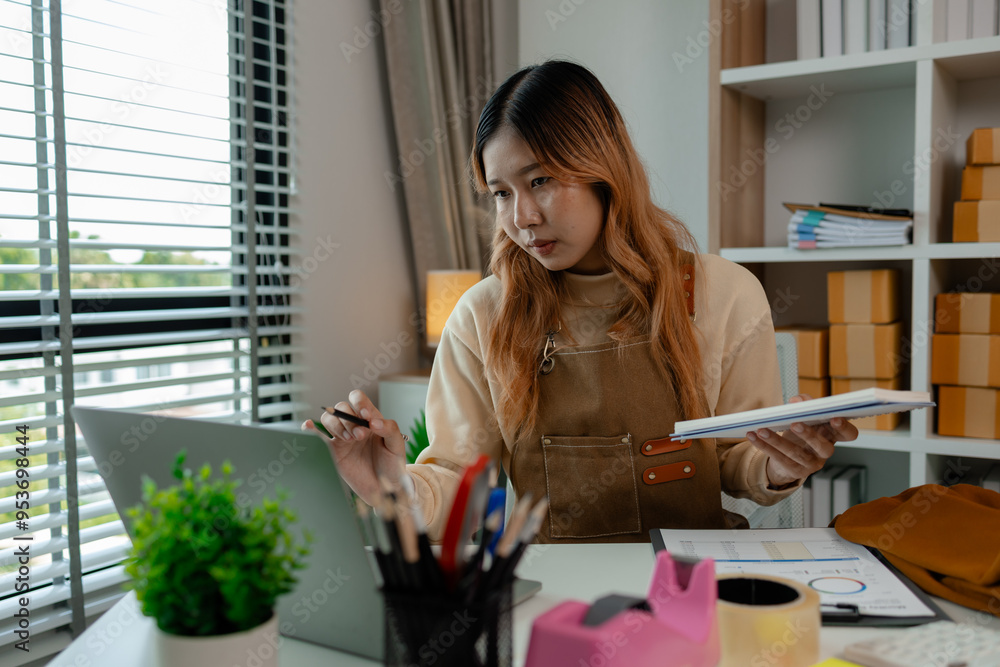 an entrepreneur or a business owner works in her office full of packages, it is a small business that she created with careful preparation, start up business of clothes an entrepreneur or a business owner works in her office full of packages, it is a small business that she created with careful preparation, start up business of clothes