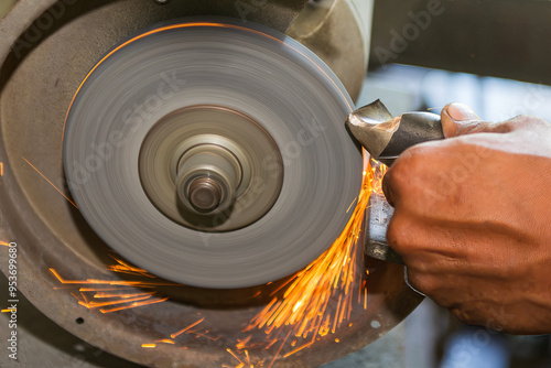 Obraz na plátně Close up scene the operator manual regrind the drill tool with sparking light