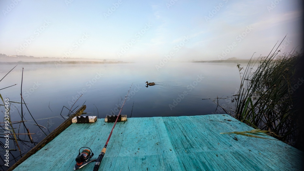 Morning fishing from blue platform on Corrib river at Galway, Ireland, fishing rod and reel, ducks and wildlife, nature background