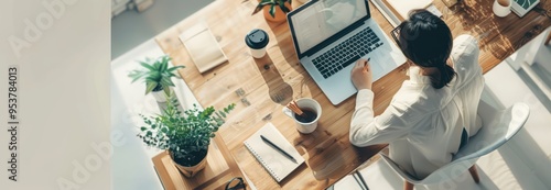Woman Working at Desk with Laptop and Plants