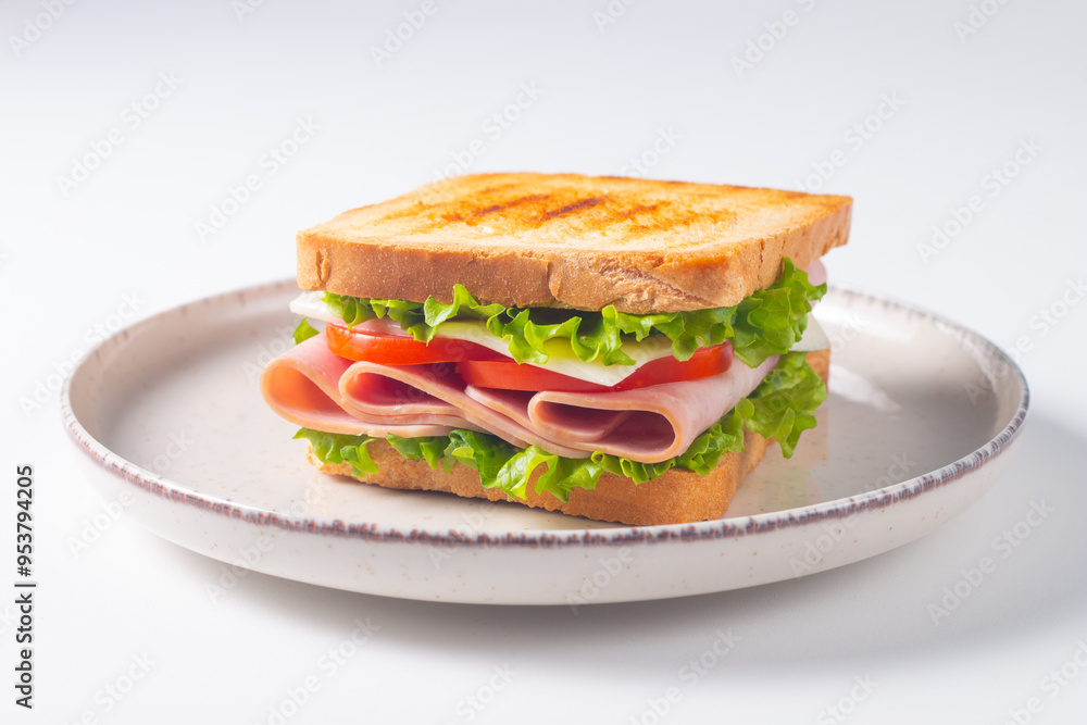 Close-up of two sandwiches with bacon, salami, prosciutto and fresh vegetables on rustic wooden cutting board. Club sandwich concept Close-up of two sandwiches with bacon, salami, prosciutto and fresh vegetables on rustic wooden cutting board. Club sandwich concept