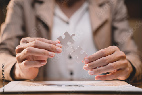 Obraz na plátně Close-up of business hands connecting jigsaw puzzle, success and goal achievement, the last jigsaw is the link of all the pieces