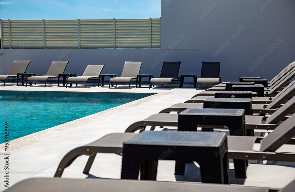Fototapeta premium swimming pool and sun loungers close up