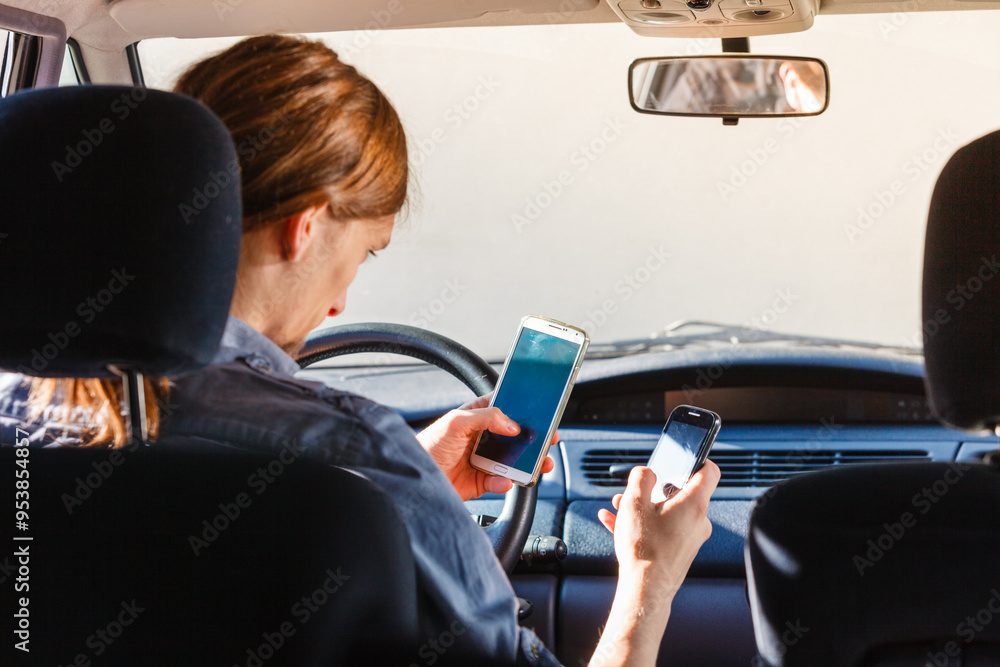 Man using his phone while driving car. Man using his phone while driving car.