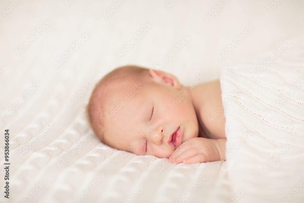 Little baby on white bed