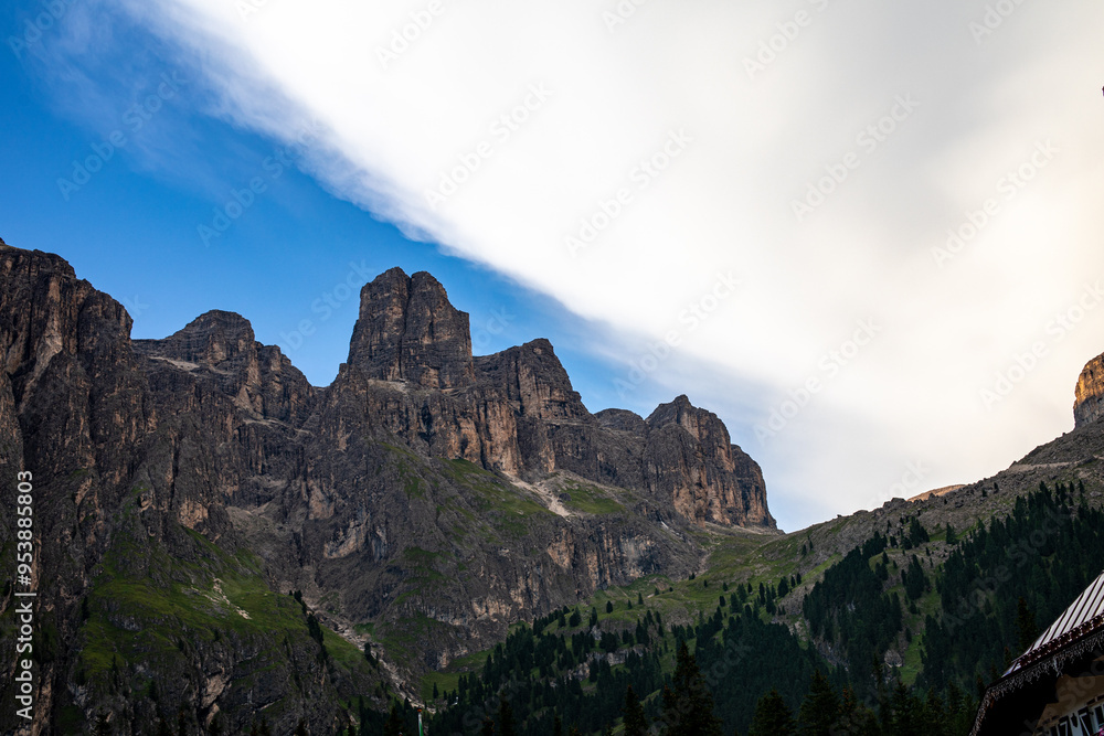 Majestic mountain landscape under a dramatic cloud formation in the Dolomites during early evening Majestic mountain landscape under a dramatic cloud formation in the Dolomites during early evening