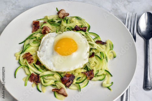 zucchini noodles with a fried egg and bacn