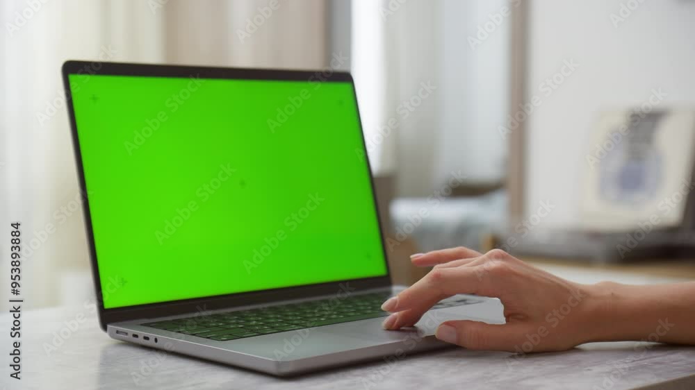 Laptop with green screen chroma key and hand on trackpad Laptop with green screen chroma key and hand on trackpad