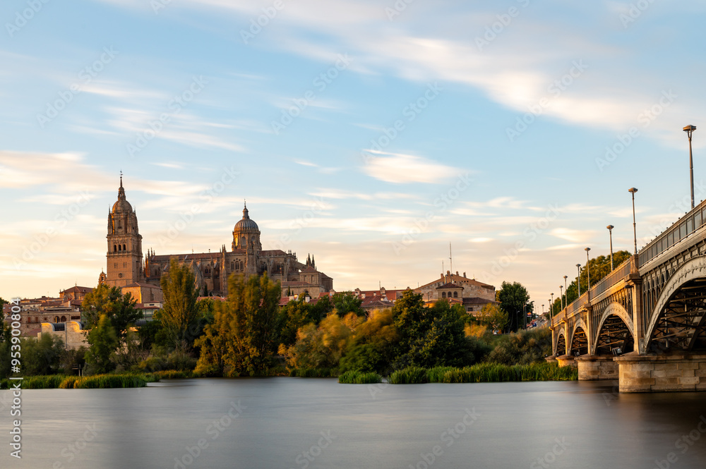 Fototapeta premium View of Salamanca (Spain) at sunset, with the cathedral and the Enrique Estevan bridge from the viewpoint of the pier on the Tormes river
