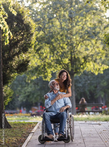 Wallpaper Mural Woman pushing man in wheelchair in park Torontodigital.ca